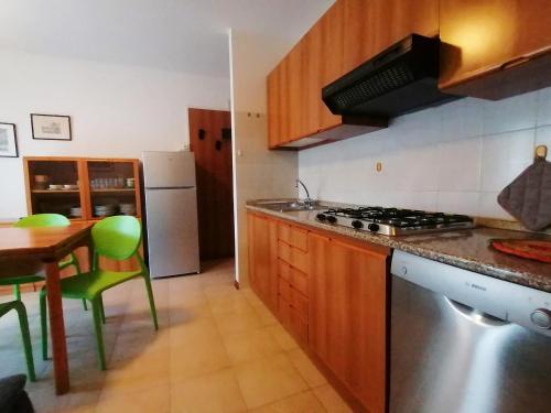 a kitchen with a table and a stove top oven at Appartamenti Rosanna in Grado