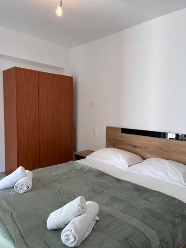 a bedroom with two towels on a large bed at Georges House in Nea Moudania
