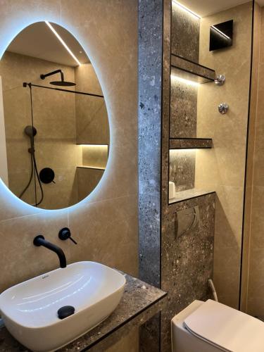 a bathroom with a sink and a mirror at Georges House in Nea Moudania