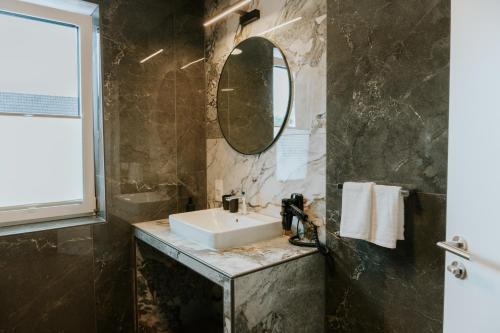 a bathroom with a sink and a mirror at Stay2sleep, Self-Check-In in Dinklage