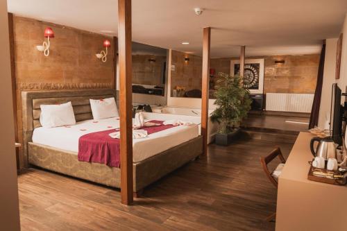 a bedroom with a large bed and a bath tub at Green House Garden Park Hotel in Istanbul