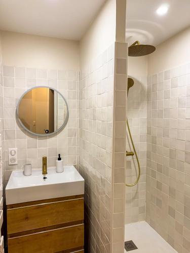 a bathroom with a sink and a mirror at La Tour Myra in Valras-Plage
