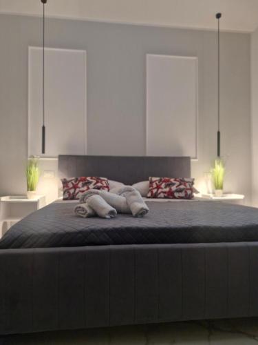 a bedroom with a large bed with two pillows at Dolce Giò A in Mazara del Vallo