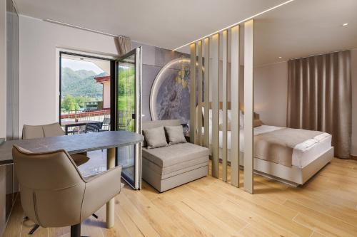a bedroom with a bed and a table and chairs at Guest House Jezero in Most na Soči