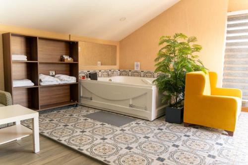 a large bathroom with a tub and a chair at Green House Garden Park Hotel in Istanbul