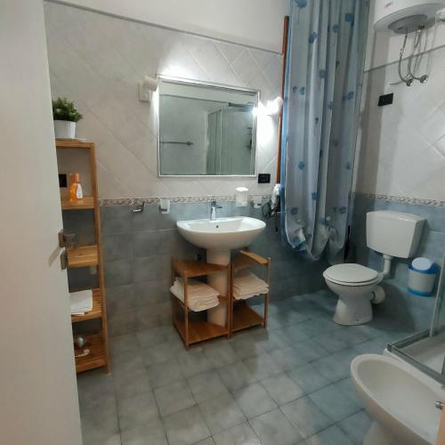 a bathroom with a sink and a toilet and a mirror at Casa Vacanza Stella del Mare in San Vito lo Capo