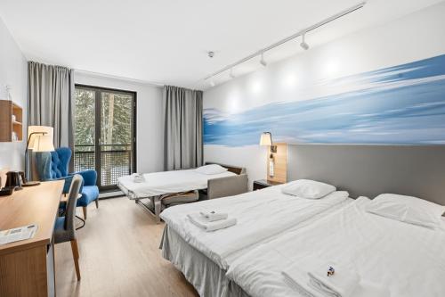 a hotel room with two beds and a desk at Imatran Valtionhotelli in Imatra
