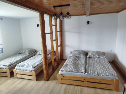 a room with three bunk beds in it at Pokoje u Juroszka in Istebna