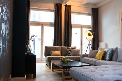 a living room with two couches and a table at Grand Canal Boutique Hotel in Amsterdam