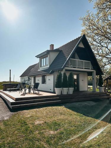 a house with a porch with potted plants on it at Supsi Saun in Supsi