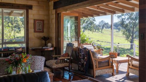 a screened in porch with rocking chairs and windows at Mountain View Farm in Portland