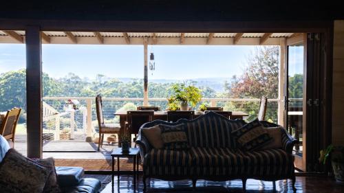 a living room with a couch and a large window at Mountain View Farm in Portland