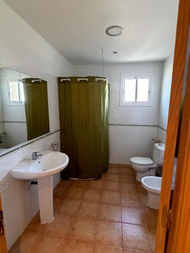 a bathroom with a sink and a shower and a toilet at Les Eres de Palouet- Casa de campo con piscina privada in Palouet