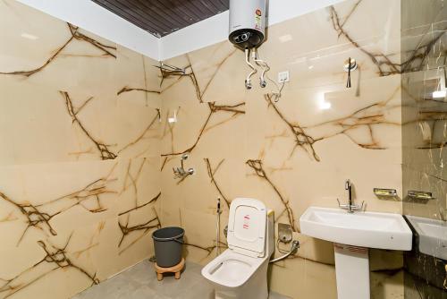 a bathroom with a white toilet and a sink at Hotel Namaste Pushkar in Pushkar