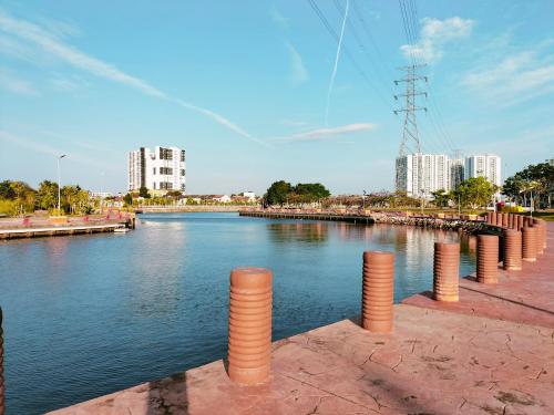 a view of a river with buildings in the background at Rivero Boutique Hotel Melaka in Malacca