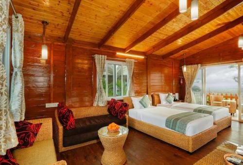a bedroom with a bed and a couch in a room at Sunny's World Resort in Pune
