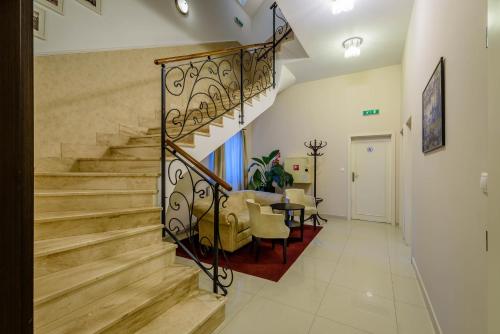 a staircase in a living room with a table and chairs at Penzión Central Park in Žilina