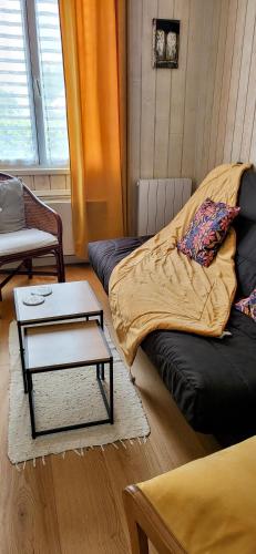 a living room with a couch and a table at CHAMBRES D'HÔTES LOPERHET in Loperhet