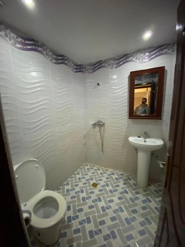 a bathroom with a toilet and a sink at Comfortable Luxury House in Merzouga