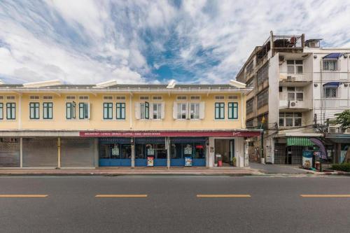 a yellow building on the side of a street at Upstairs at Ton Ton in Bangkok