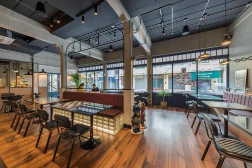 a restaurant with tables and chairs in a room at Upstairs at Ton Ton in Bangkok