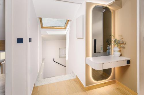 a bathroom with a sink and a mirror at Guest House Jezero in Most na Soči