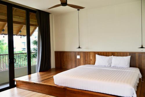 a bedroom with a bed and a large window at Soleil House in Hue