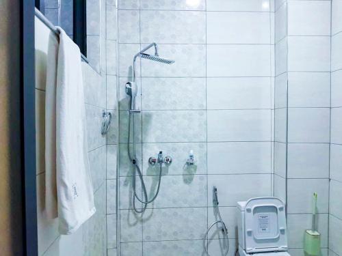 a bathroom with a shower and a toilet at RIVANA HOTEL Goba in Dar es Salaam