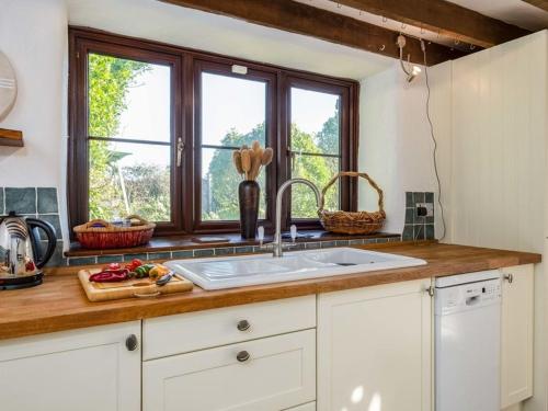 a kitchen with a sink and a window at Trehaverock Cottage in Port Isaac