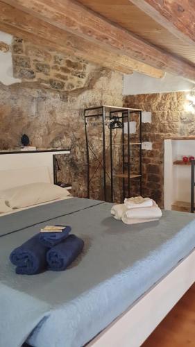 a bedroom with a bed with blue towels on it at Casa ArTè in Modica