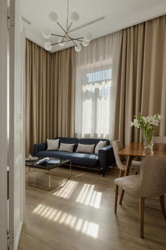 a living room with a blue couch and a table at Oikia Classic House in Old Town Kavala in Kavála