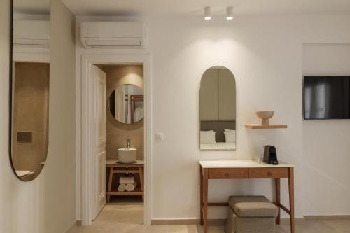 a bathroom with a sink and a mirror at Nami Hotel & Suites in Stalís