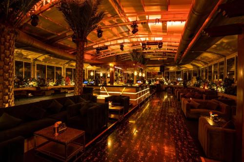 a large room with couches and a bar at Peninsula Grand in Mumbai
