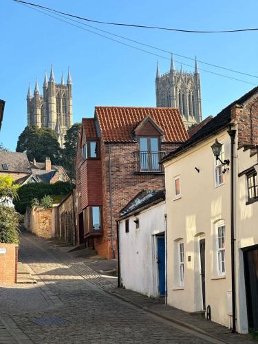 a street with buildings and a cathedral in the background at The Nook Lincoln in Lincolnshire