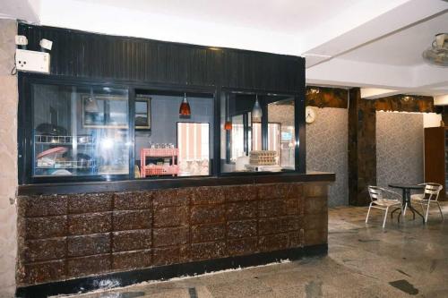 a display case in a restaurant with a table and chairs at Collection O Luna Hotel Pattaya in Pattaya