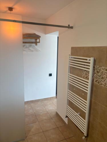 a room with a white door and a tile floor at MIK Chalet in Săcele