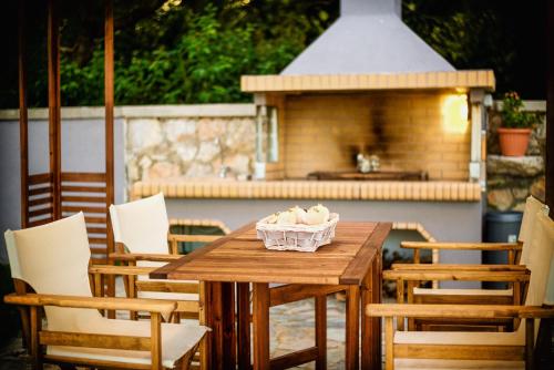 a wooden table with a bowl of ice cream on it at Villa Arokaria in Tsilivi
