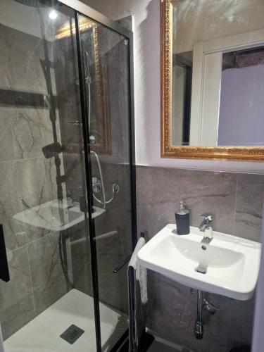a bathroom with a sink and a shower at DuomoHome1 in Pietrasanta