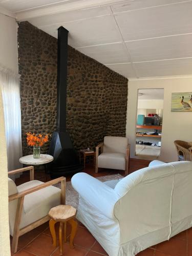 a living room with a couch and a fireplace at River Glen Farm in Winterton