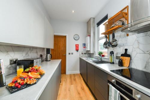 a kitchen with a tray of food on a counter at Long Eaton Modern 4bed House in Long Eaton