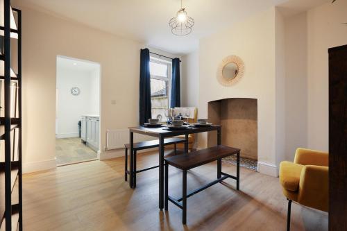 a living room with a table and a chair at 3-Bed Home Perfect for Exploring Nottingham & Derby in Long Eaton