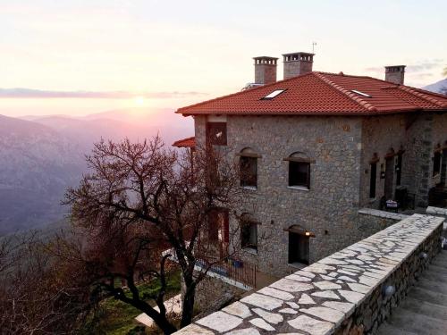 a building on the side of a mountain with a view at AlmondHouse Suites with Fireplace - ADULTS ONLY in Arachova