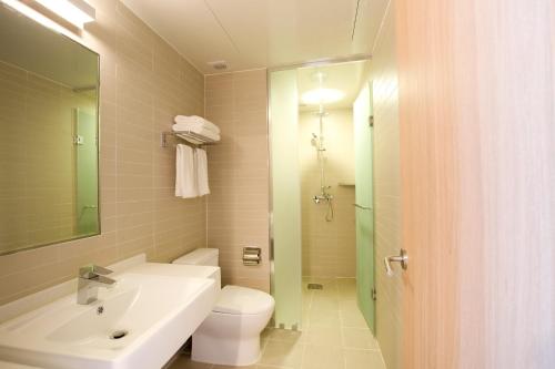 a bathroom with a sink and a toilet and a mirror at Grid Inn Hotel in Seoul