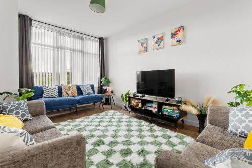 a living room with two couches and a tv at Stylish & Spacious Home in the Heart of Leeds in Central Station