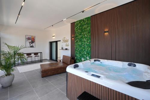 a jacuzzi tub in a living room at taira suite in Rosh Pinna