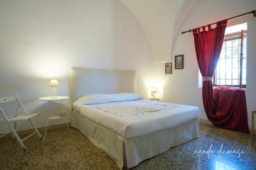 a bedroom with a bed and a window at Masseria Giangrande - Rooms and Apartment in Polignano a Mare