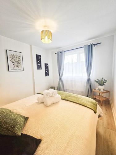 a bedroom with a bed with two towels on it at Central Hideout in Birmingham