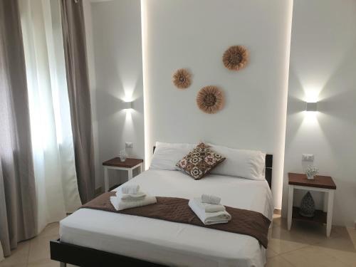 a bedroom with a large white bed with two night stands at B&B Colori del Salento in Presicce