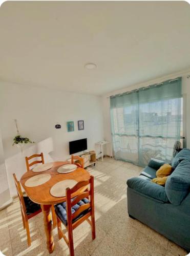 a living room with a table and a couch at Barbate Beach Apartment in Barbate