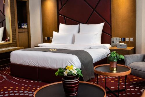 a hotel room with a bed and a couch at Redwaves Hotel in Jeddah